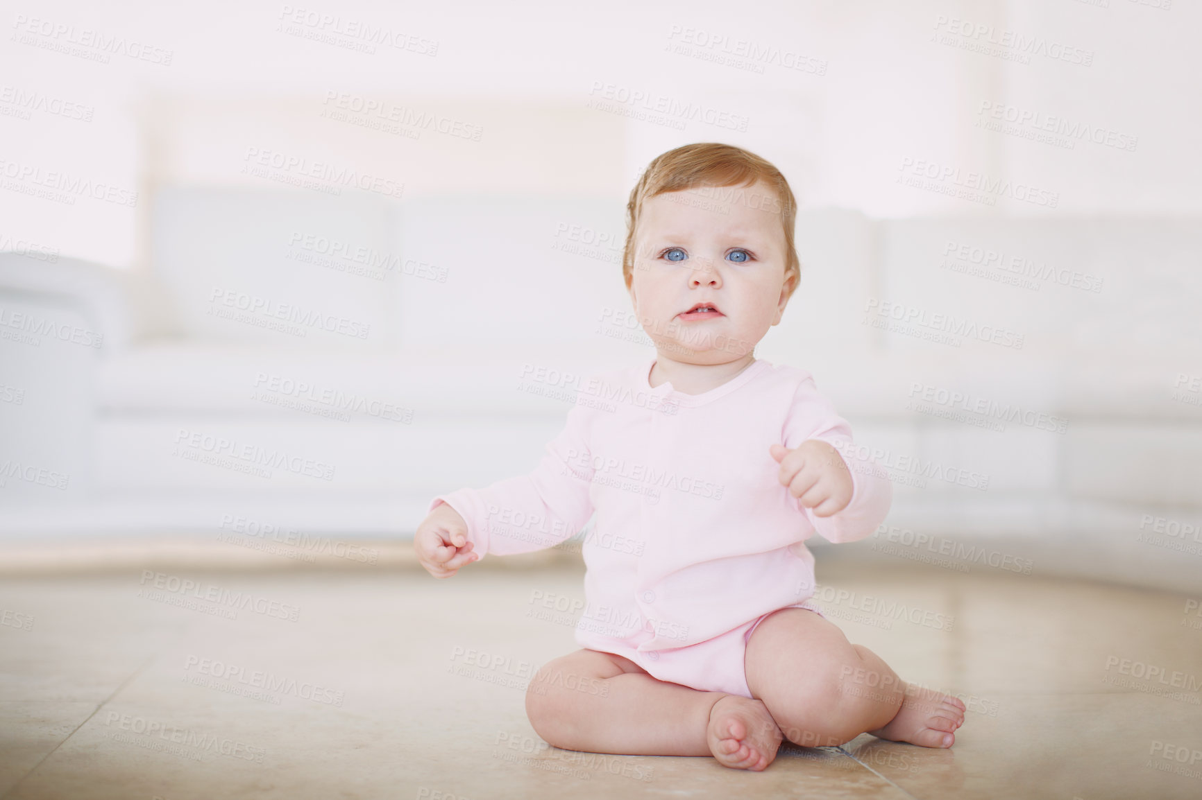 Buy stock photo An adorable baby girl sitting by herself on the living room floor