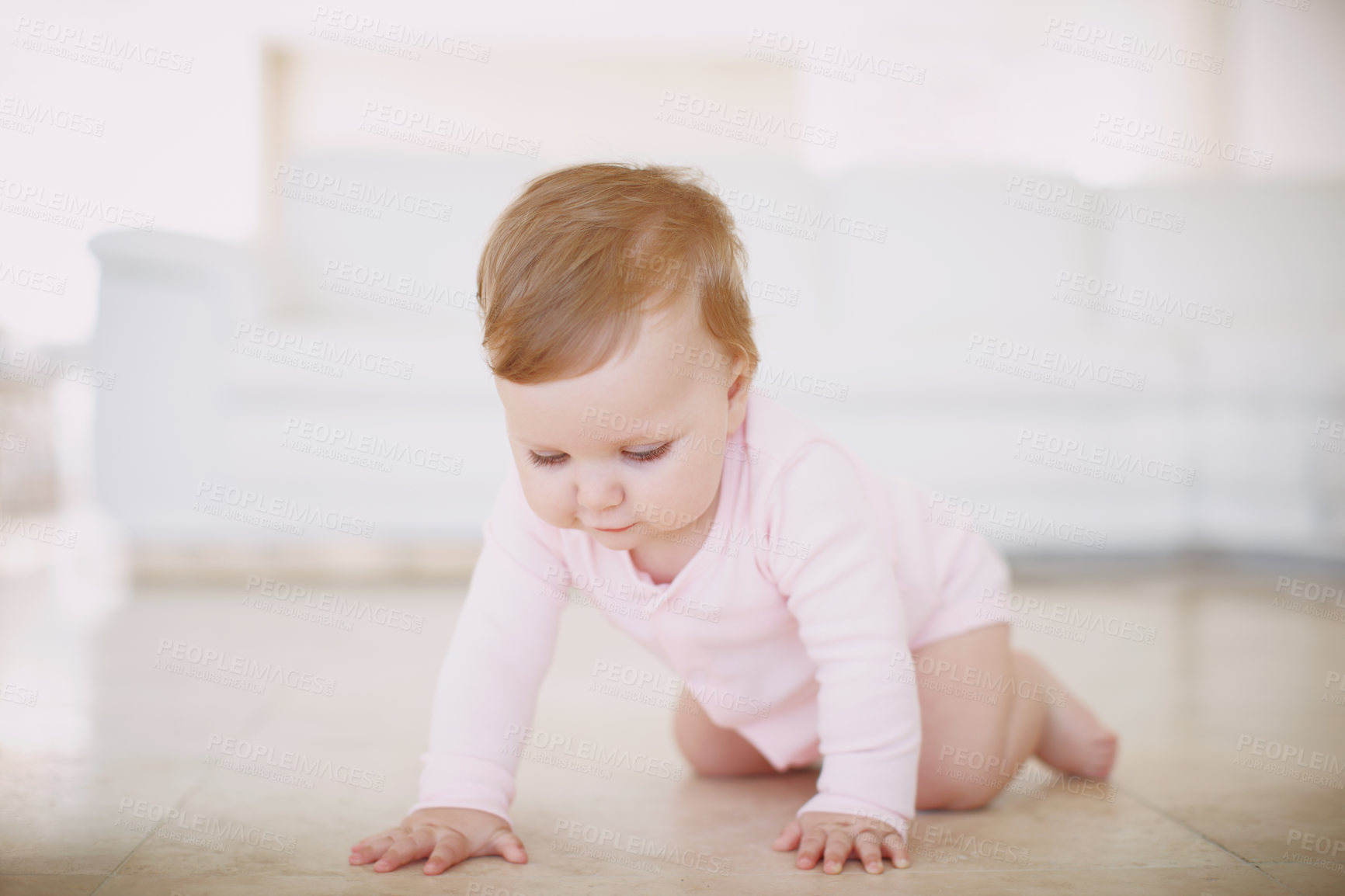 Buy stock photo A little baby girl crawling on the floor of a living room