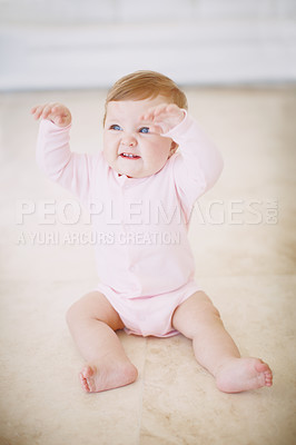 Buy stock photo An adorable baby girl sitting on the floor and being playful