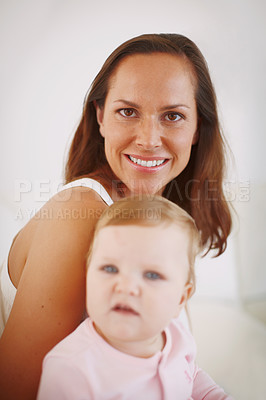 Buy stock photo Portrait of a loving mother holding her baby girl