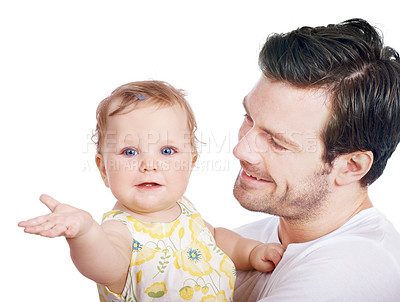 Buy stock photo A young dad standing with his lovely baby daughter in his arms