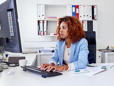 Buy stock photo Shot of a young businesswoman working on her desktop computer