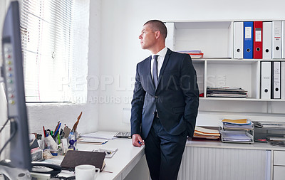 Buy stock photo Shot of a well-dressed businessman standing in his office