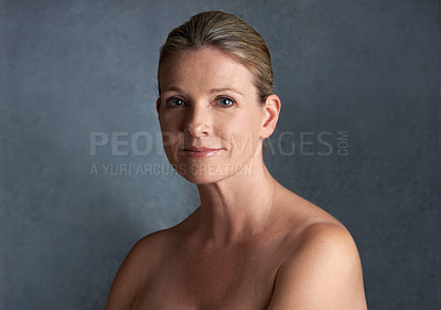 Buy stock photo Cropped studio portrait of a beautiful mature woman with bare shoulders