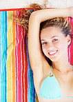 Vacation - Smiling female relaxing on a towel in bikini