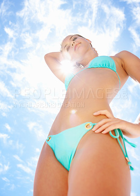 Buy stock photo Woman, bikini and low angle in sunshine, blue sky background and freedom for thinking, holiday or lens flare. Girl, vision and swimwear in summer, vacation and outdoor in nature for wellness in Spain