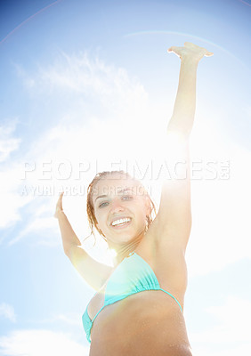 Buy stock photo Woman, happy and bikini in sunshine, blue sky background and hands in air for freedom, holiday and excited. Girl, smile and swimwear in summer, vacation and outdoor in portrait for wellness in Spain