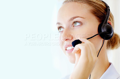 Buy stock photo Closeup portrait of a young call center employee using a headset on white