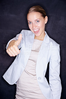 Buy stock photo Portrait of a pretty young business woman showing you the thumbs up sign against black