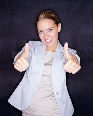 Buy stock photo Pretty business woman showing you the success sign on black background