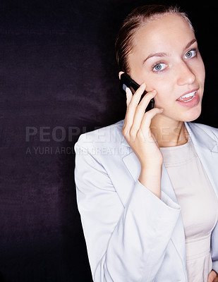 Buy stock photo Pretty business woman looking confused over a conversation on the cellphone