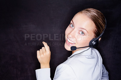 Buy stock photo Happy young business executive with a headset isolated against black background