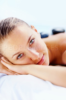 Buy stock photo Portrait, spa and woman with hot stone massage, relax or stress relief body treatment at a wellness resort. Luxury, zen and face of female person at a salon for healing, therapy or vacation pamper