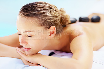 Buy stock photo Hot stone, massage and woman sleep at a spa for wellness treatment and detox. Calm, muscle healing recovery and a female person with sleep at a resort or hotel with beauty therapist with skincare
