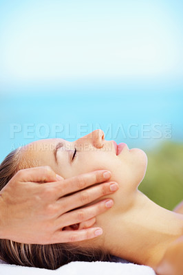 Buy stock photo Woman, head massage and bed at spa for health, wellness of rest in recovery, peace or quiet in nature. Girl, mockup space and resort in rehabilitation, massage or blue sky background for body fatigue