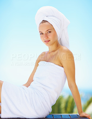 Buy stock photo Portrait, woman and spa towel outdoor with wellness, skincare and health treatment with blue sky. Tropical, rest and zen of a calm female person on vacation with body care and ready for massage