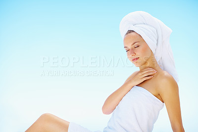Buy stock photo Relax, woman and spa towel outdoor with wellness, skincare and health treatment with blue sky. Mockup space, rest and zen of a calm female person on vacation with body care and ready for massage