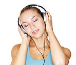 Beautiful young female listening to music over headphones