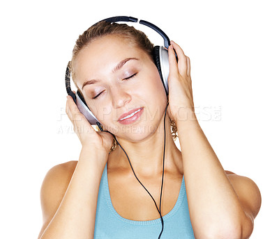 Buy stock photo Cute young female enjoying music over headphones isolated against white