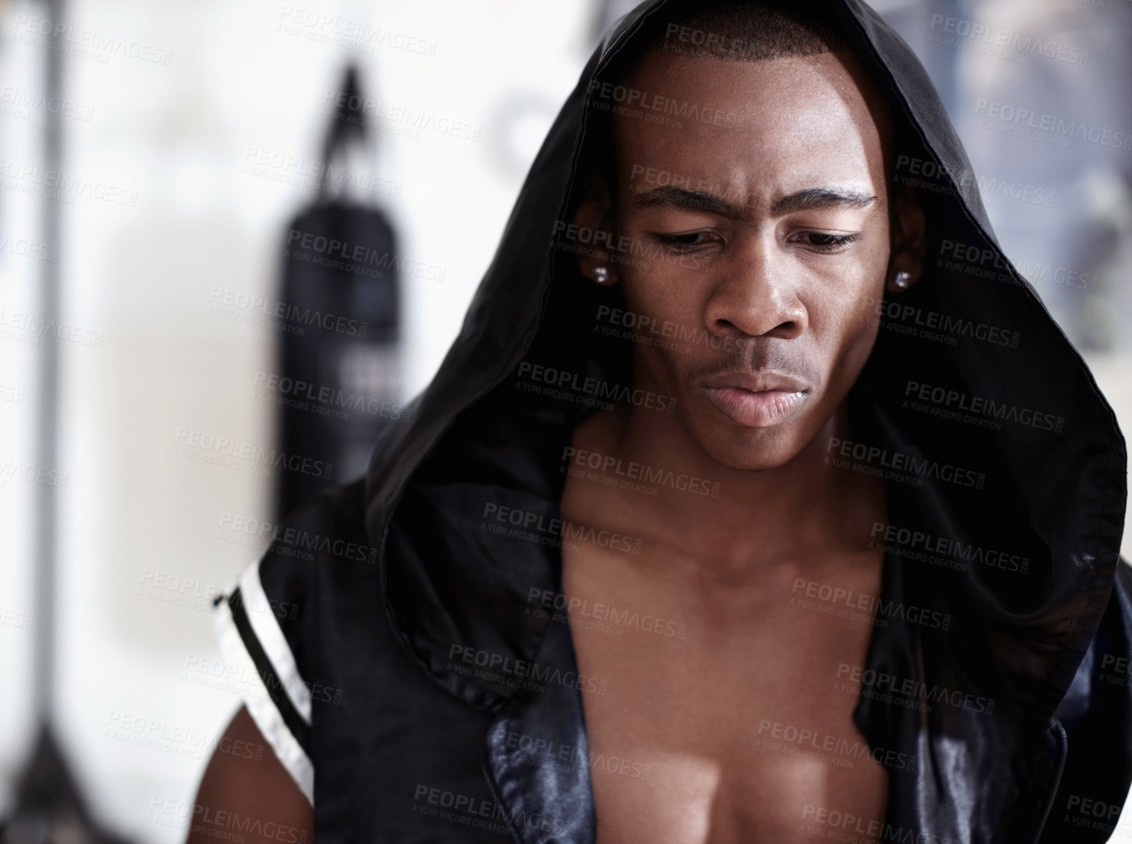 Buy stock photo Muscular African American male boxer wearing hooded robe