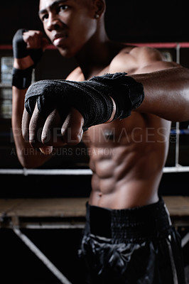 Buy stock photo African American athletic man with wrapped fists punches