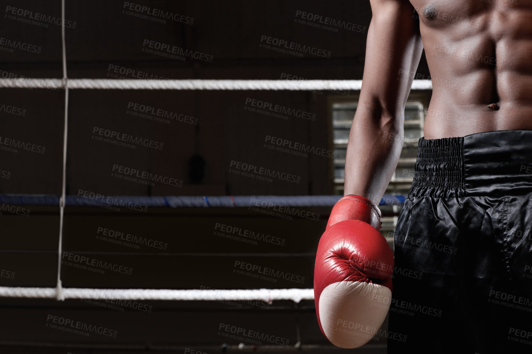 Buy stock photo Muscular man standing in ring wearing boxing gloves