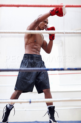 Buy stock photo African American athletic man practicing in ring