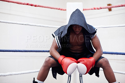 Buy stock photo African American male boxer in black hood wearing boxing gloves