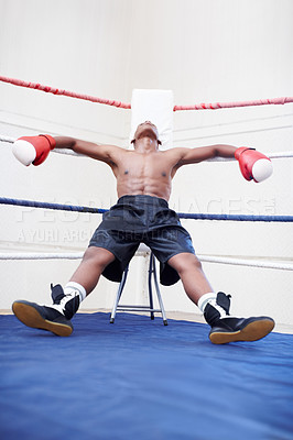 Buy stock photo African American male boxer relaxing in ring