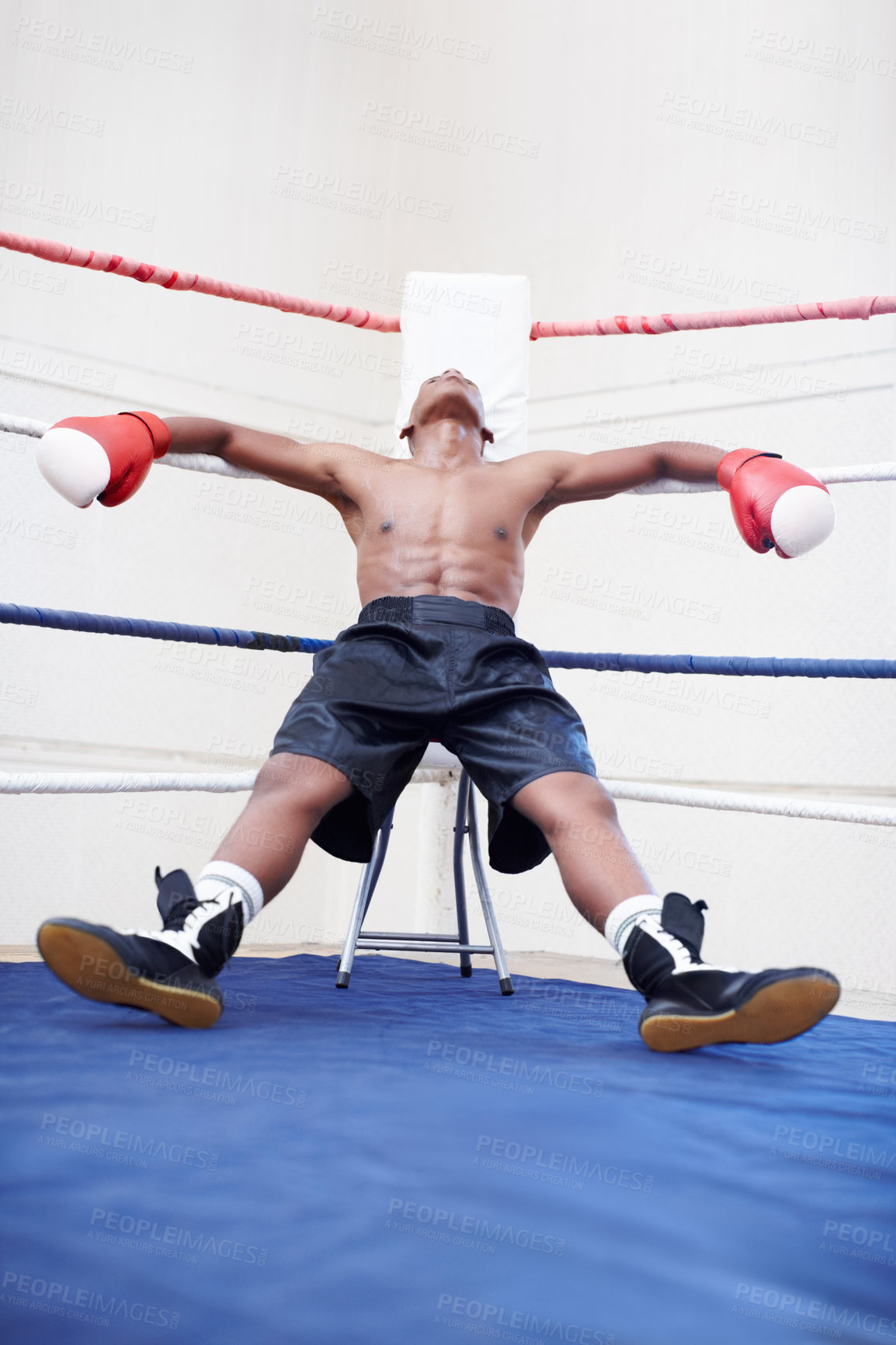 Buy stock photo African American male boxer relaxing in ring