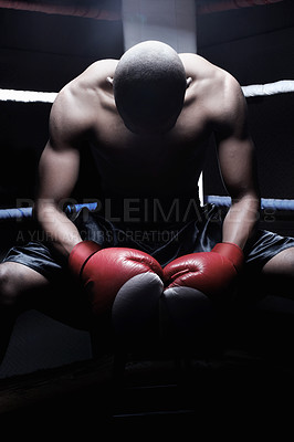 Buy stock photo African American male boxer sitting in ring with head down