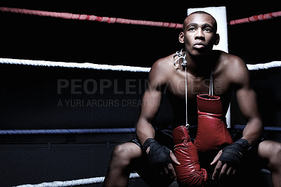 Buy stock photo Handsome African American boxer sitting with boxing gloves hanging on neck