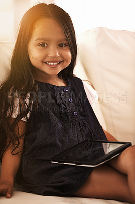 Buy stock photo Portrait, happy and little girl with tablet on sofa for entertainment, elearning or social media at home. Face of female person, child or kid with smile, technology or ebook in living room at house