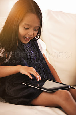 Buy stock photo Little girl, child and tablet on sofa in entertainment, elearning or social media with lens flare at home. Face of female person or kid browsing on technology or reading ebook in living room at house