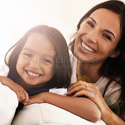 Buy stock photo Happy mom, portrait and child on sofa for love, bonding or care with lens flare at home. Face of mother, parent or little girl, daughter or kid with smile in living room for family weekend or support