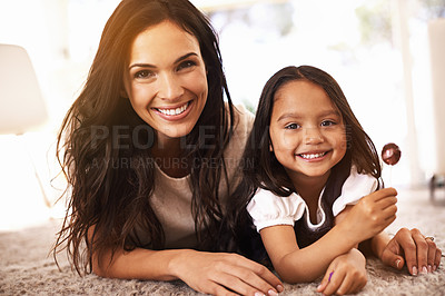 Buy stock photo Happy, mom and portrait with child and lollipop on floor in relax for family bonding, love or care together at home. Face of mother, parent and little girl, daughter or kid with smile in living room