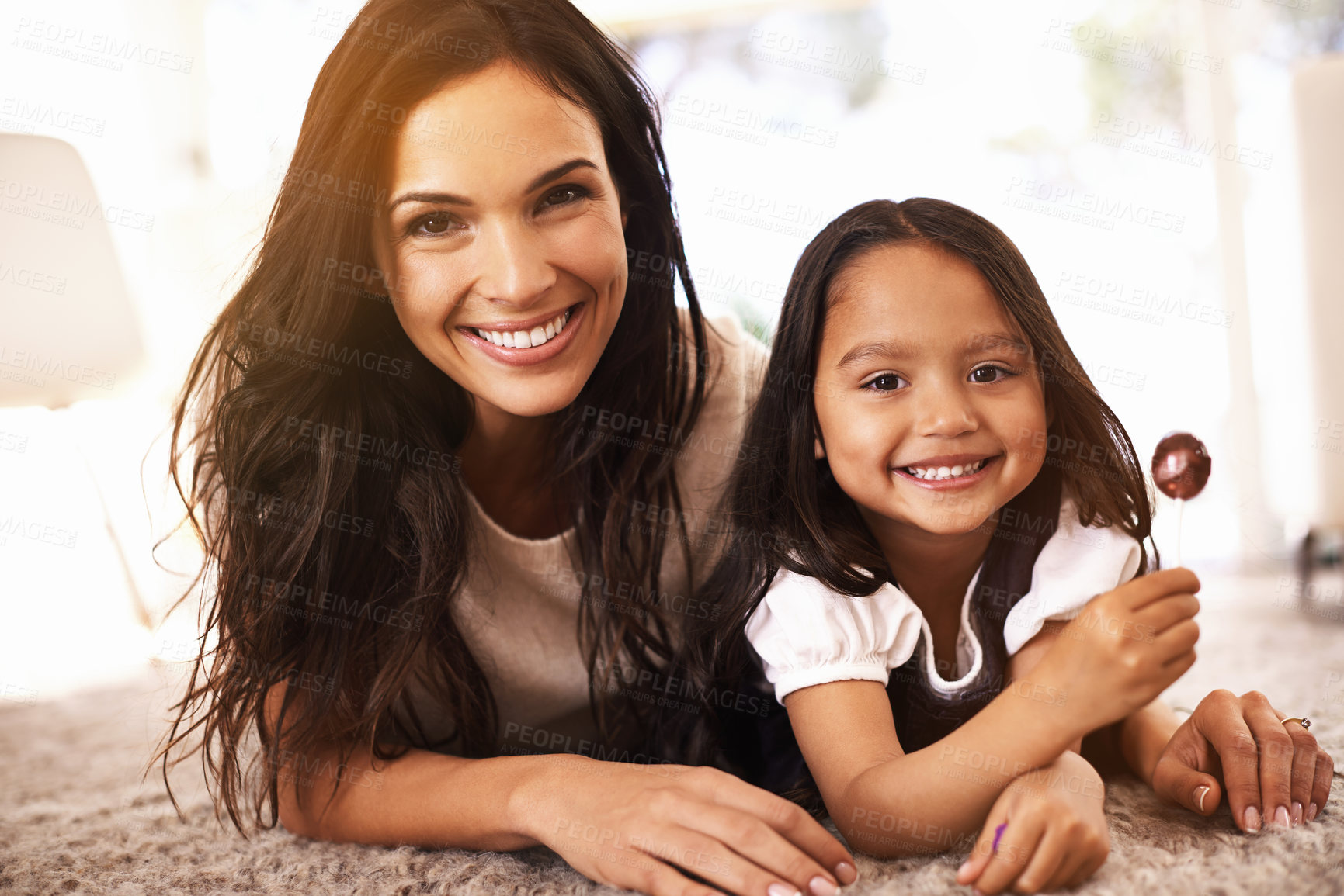 Buy stock photo Happy, mom and portrait with child and lollipop on floor in relax for family bonding, love or care together at home. Face of mother, parent and little girl, daughter or kid with smile in living room