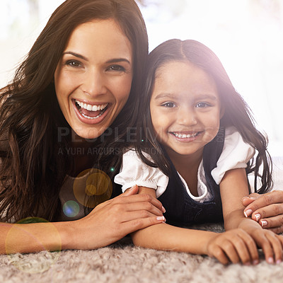 Buy stock photo Happy mother, portrait and little girl lying on floor in relax for bonding, love or care together at home. Face of mom, parent and child, daughter or kid with smile in living room for family time