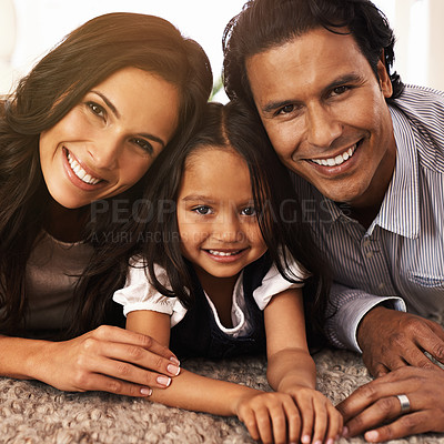 Buy stock photo Happy family, portrait and relax on floor for love, bonding or care together at home. Face of Mother, father and little girl, daughter or child with smile in living room for holiday weekend at house