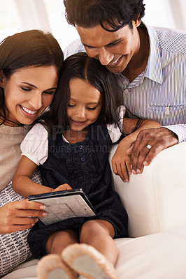 Buy stock photo Happy family, tablet and entertainment on living room sofa for social media, games or reading ebook at home. Mother, father and daughter on technology for online streaming, internet or app at house
