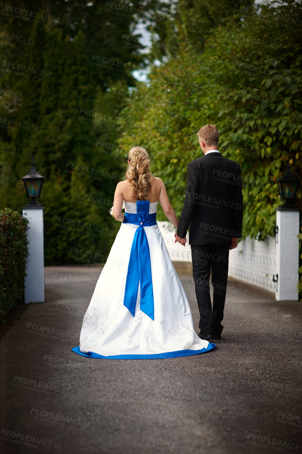 Buy stock photo Rearview shot of a bride and groom on their wedding day