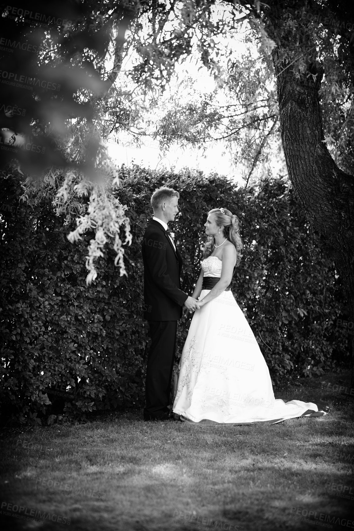 Buy stock photo Full length shot of a bride and groom on their wedding day in grayscale