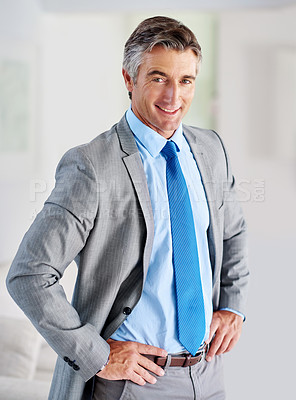 Buy stock photo Portrait of a smiling mature businessman standing with his hands on his hips
