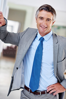Buy stock photo Portrait of a smiling mature businessman leaning against a wall