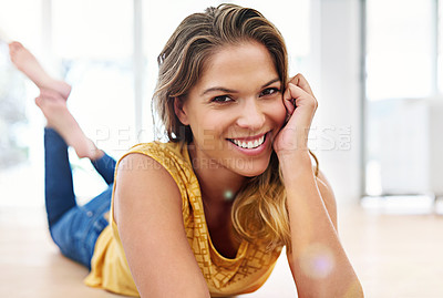 Buy stock photo Portrait of a young woman lying on her living room floor