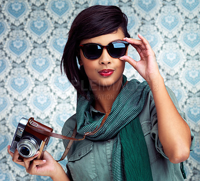 Buy stock photo Sunglasses, photography and portrait of woman with camera and funky, trendy and cool fashion for job. Smile, photographer and female person with casual outfit and vintage dslr equipment by wallpaper.