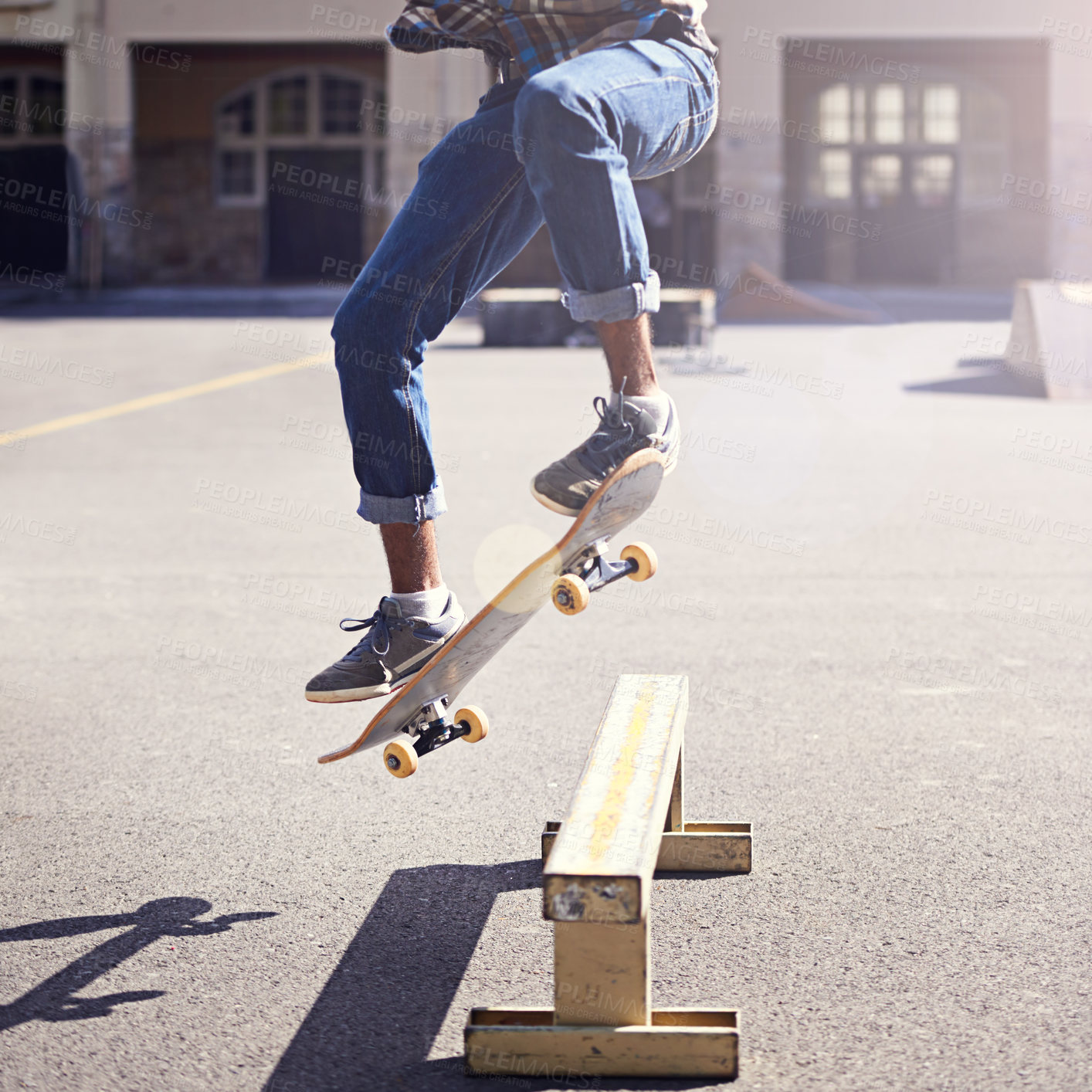 Buy stock photo Cropped shot of a young man doing a skateboarding trick