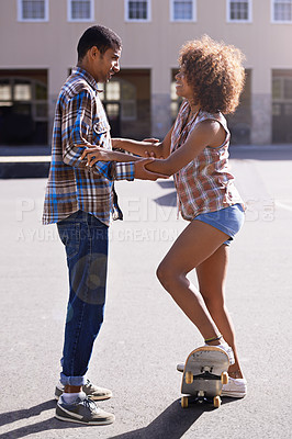Buy stock photo Smile, teaching and man with woman on skateboard in city on romantic and fun date together. Happy, couple and African female person learning skating with boyfriend skater in urban town with love.