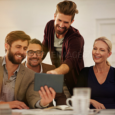 Buy stock photo Cropped shot of a group of businesspeople looking at a tablet in the boardroom