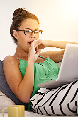 Buy stock photo Tired, female person and yawn on sofa laptop or working, sleepy and exhausted in living room. Woman, casual outfit or clothes and glasses in couch or lounge and cup of coffee in house or home